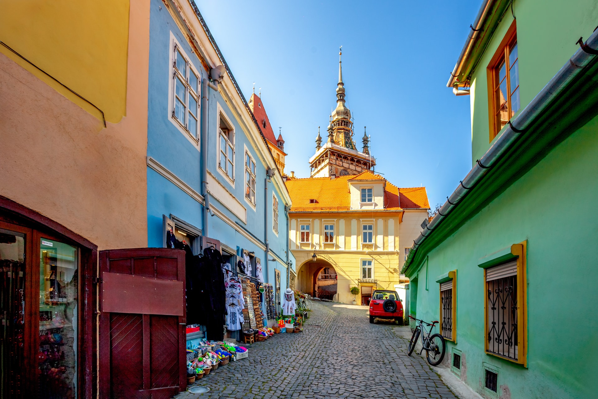 Cobblestone street in Sighisoara, Romania, leading toward the Clock Tower.